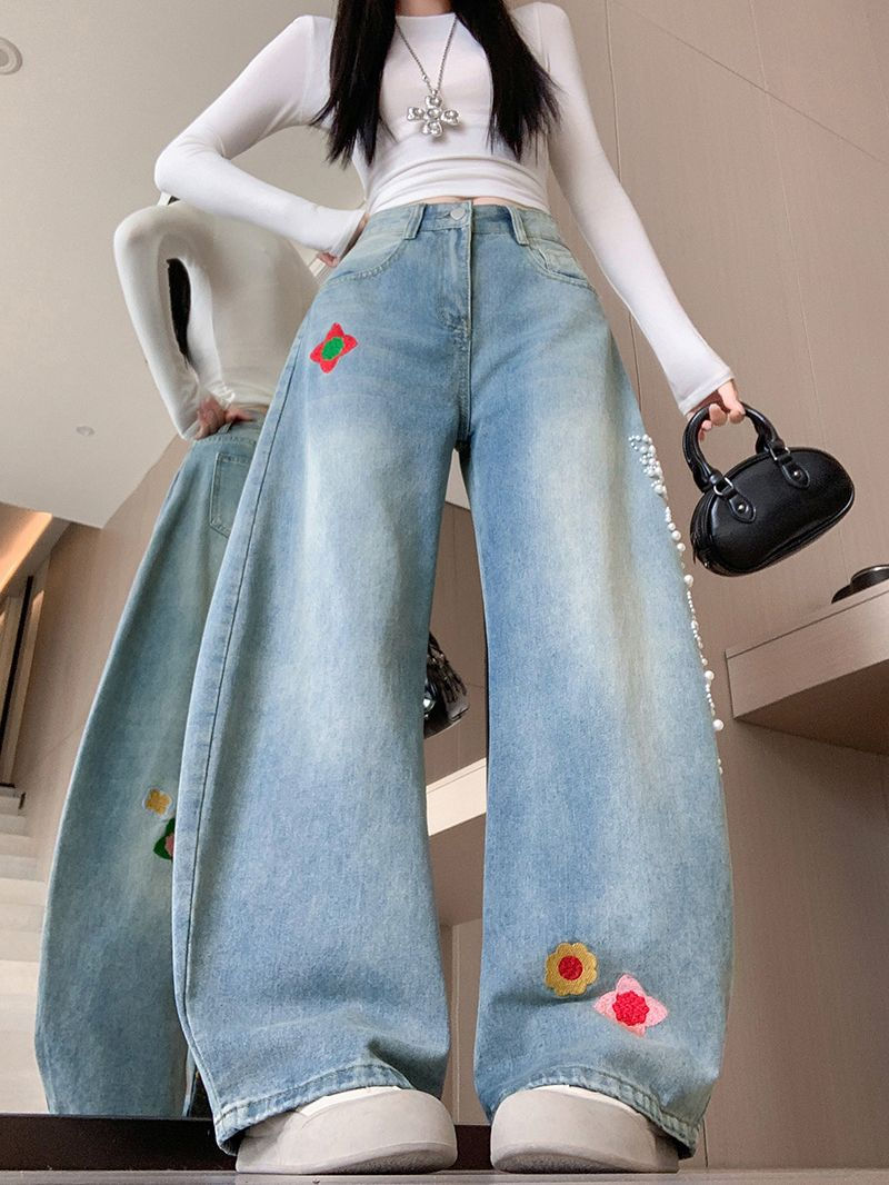 レトロな刺繍とビーズがあしらわれた、ゆったりとしたカーブシルエットのジーンズ