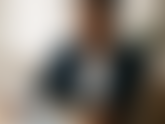 A public health administrator reviewing community data on a laptop in a calm office setting, symbolizing strategic decision-making and local leadership.