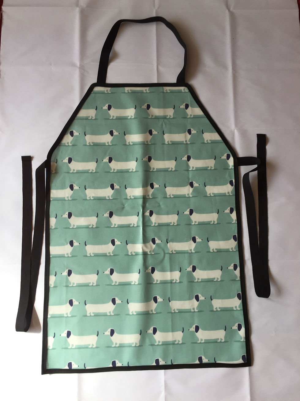 Thumbnail: Dachshund patterned apron with black straps on a white background Top Dog Show Supplies