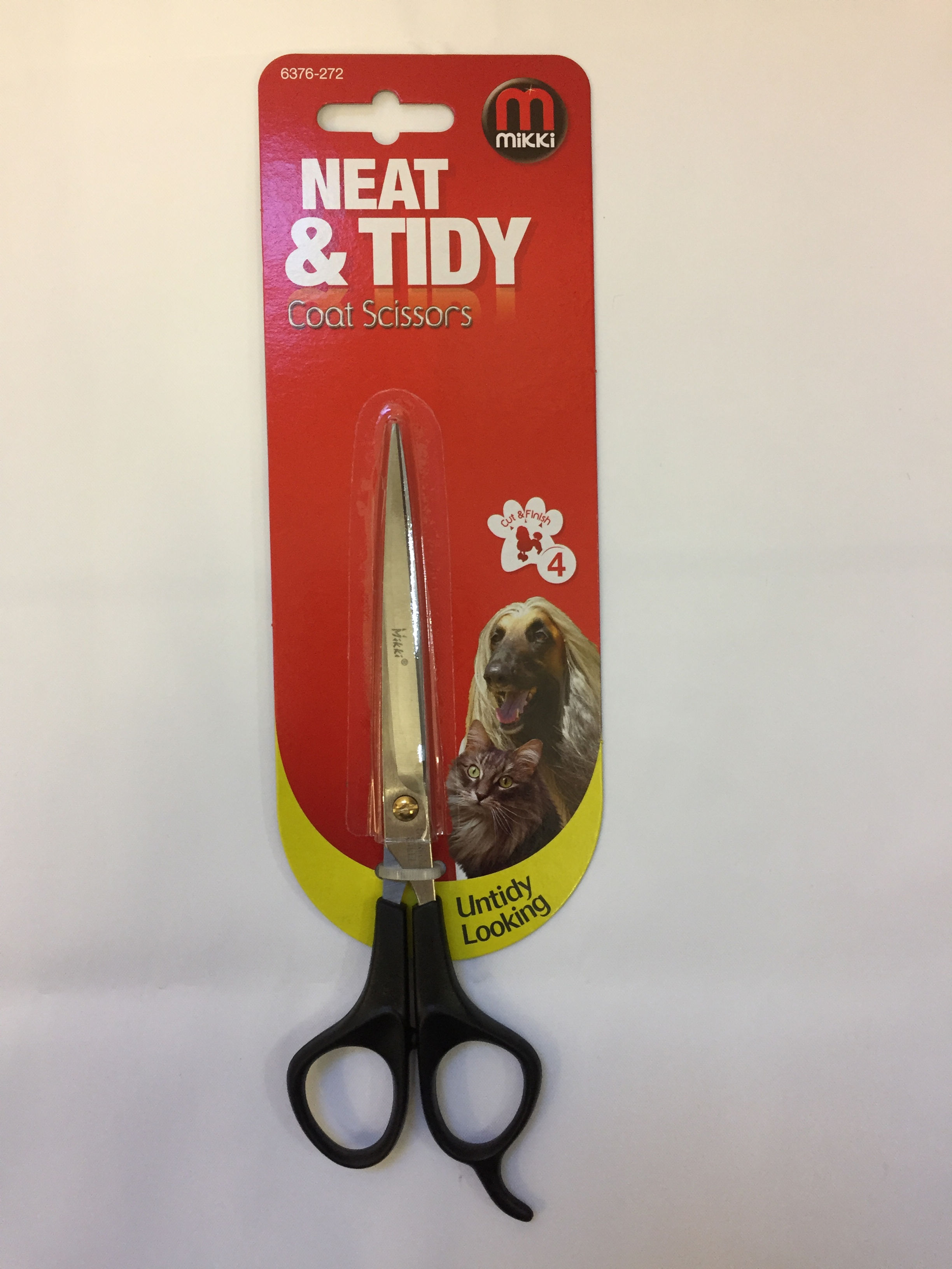 Neat & Tidy dog grooming shears on red packaging for pet care.