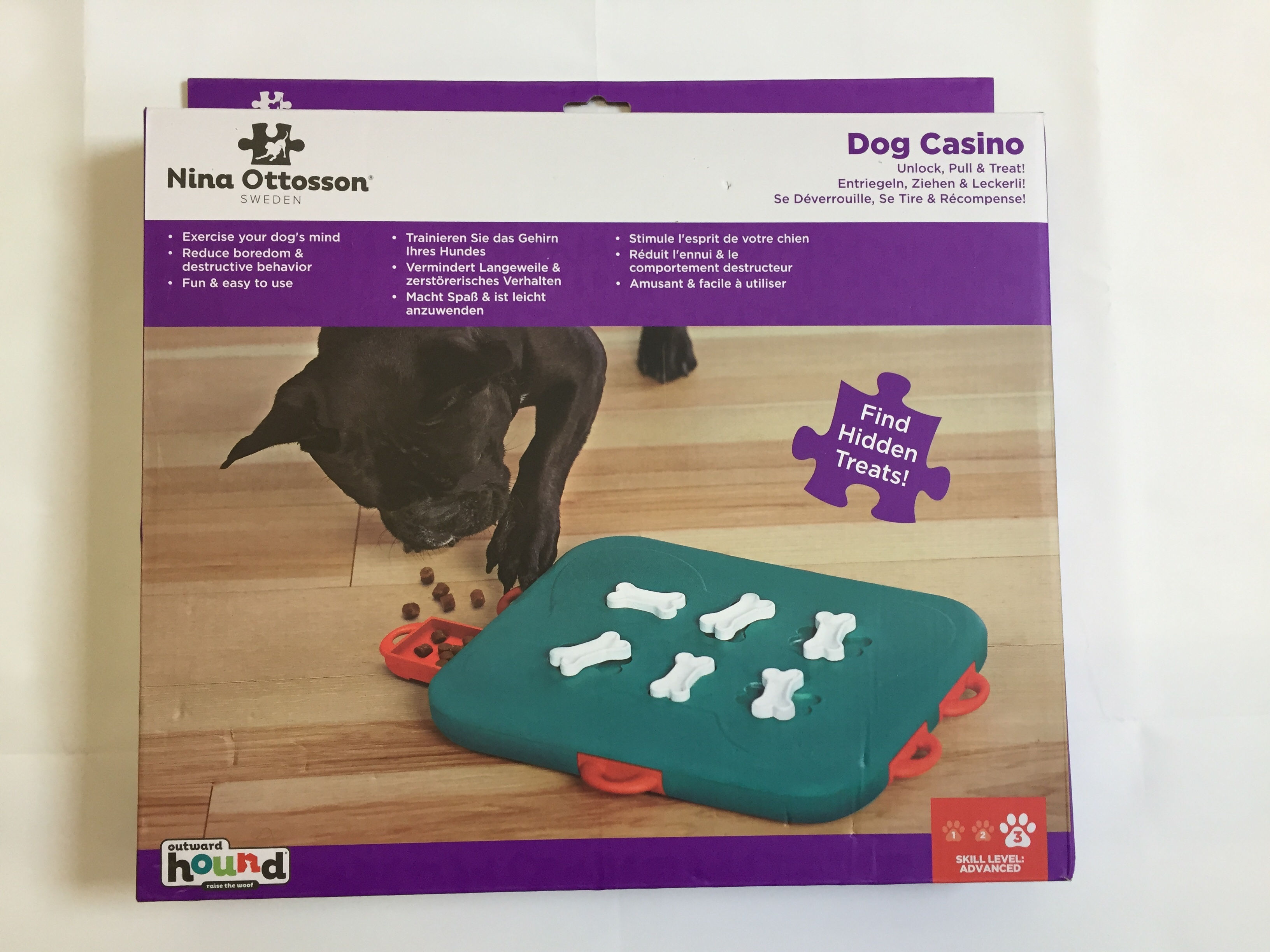 Nina Ottosson Dog Casino game box with puzzle toys, find hidden treats.