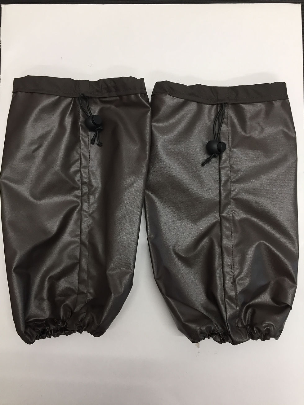 Thumbnail: Two brown leather dog leg protection covers with drawstrings for dogs.
