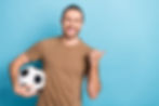 Photo of good mood pretty man wear beige t-shirt holding football ball thumb empty space i