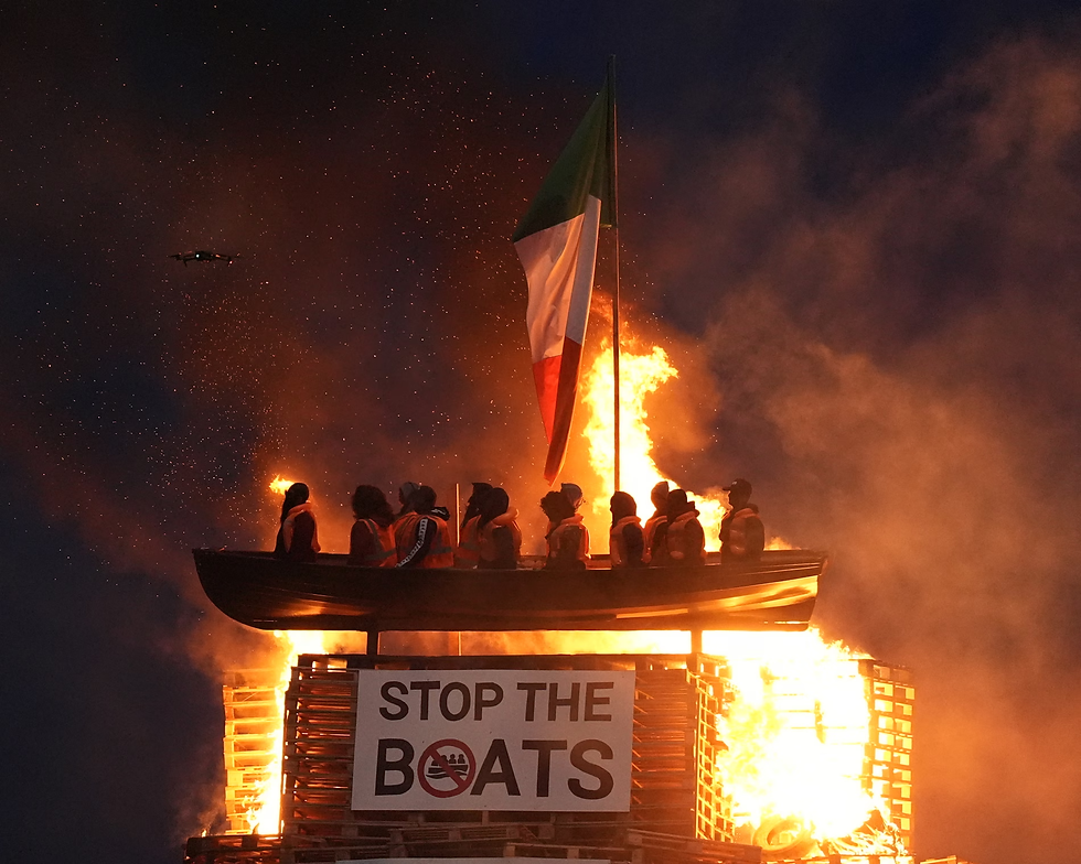 Crowds in Moygashel cheered on Thursday night when the towering pyre was lit and flames engulfed the representation of a refugee vessel. (Niall Carson | PA)