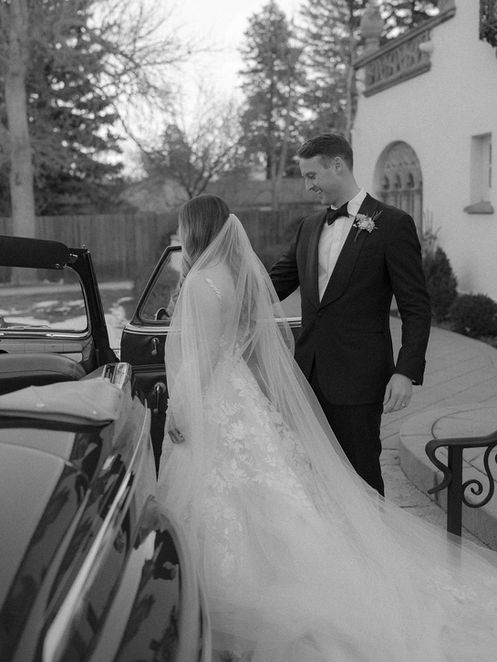 newlyweds get into their convertible at the end of their wedding