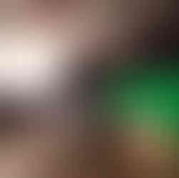 Gaffer working with lighting equipment behind vintage car inside studio