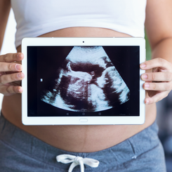 pregnant-woman-holding-and-showing-digit