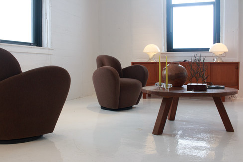 Modern furtniture sitting in a white concrete room
