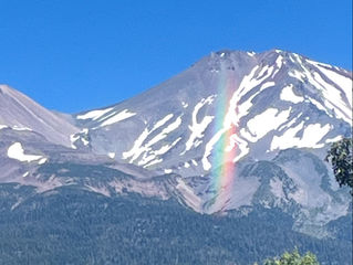 picture of Mt Shasta, CA with a rainbow in front