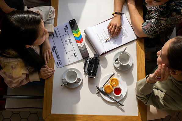 People discussing a film script at a table