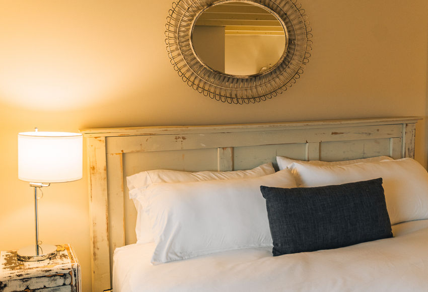 Cozy bed and warm lamp in luxury guesthouse rooms