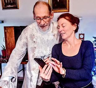 Custom-made historical costume designer posing with a client in 18th century attire.