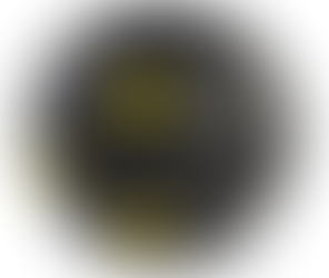 A black rubber dog toy with three yellow dots on it