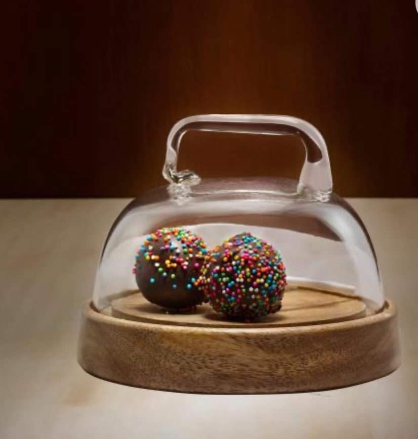 Glass dome cloche with a wooden base