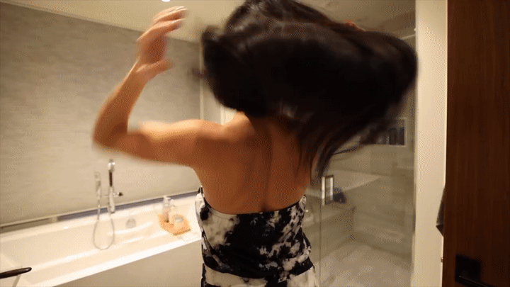 Woman washing and styling hair