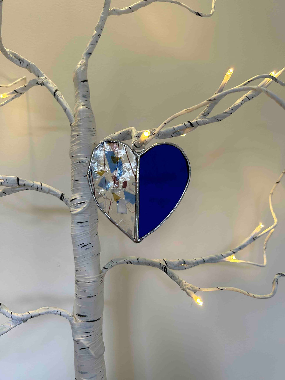Thumbnail: One half patterned  and half blue coloured stained glass hearts