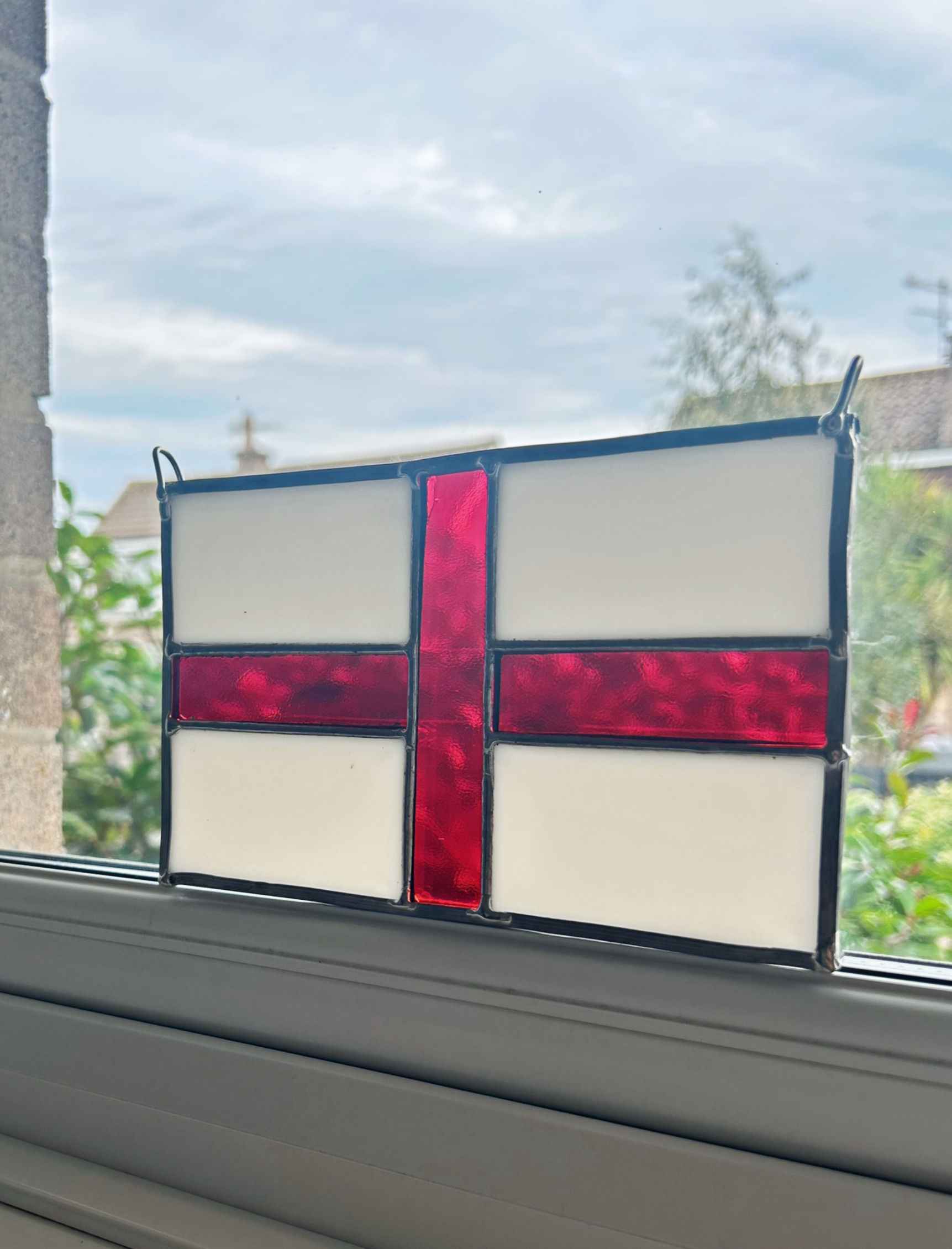Large England flag in stained glass with leaded frame in window