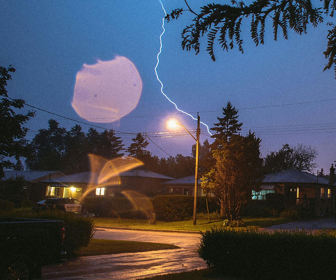 Lightning striking behind a house during bad weather_edited.jpg