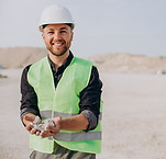 worker-sand-quarry-holding-rocks.jpg