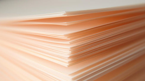 an extreme closeup of a pad of very thin delicate paper pages, in a peachy colour (1).jpg