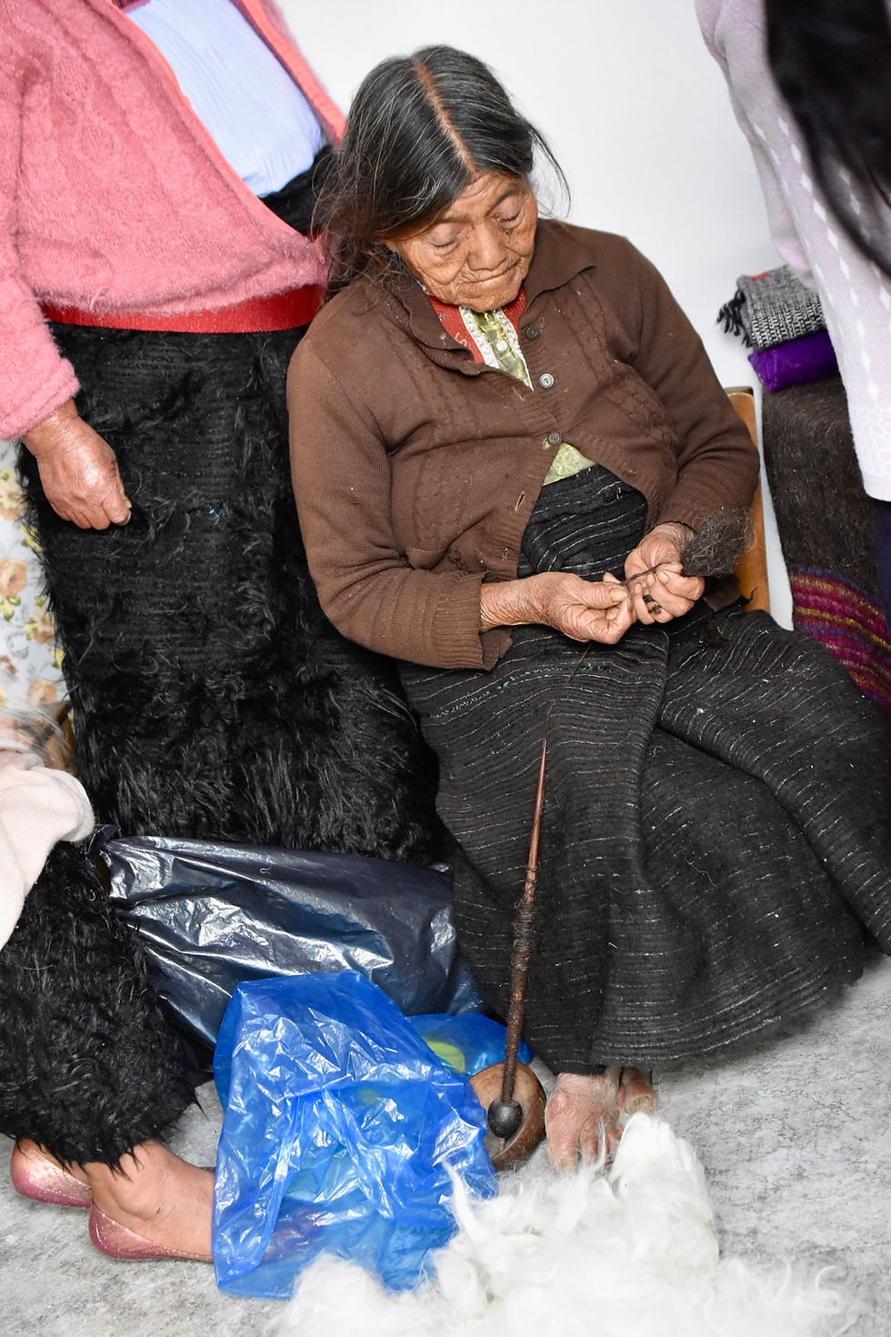 Maya woman spinning wool