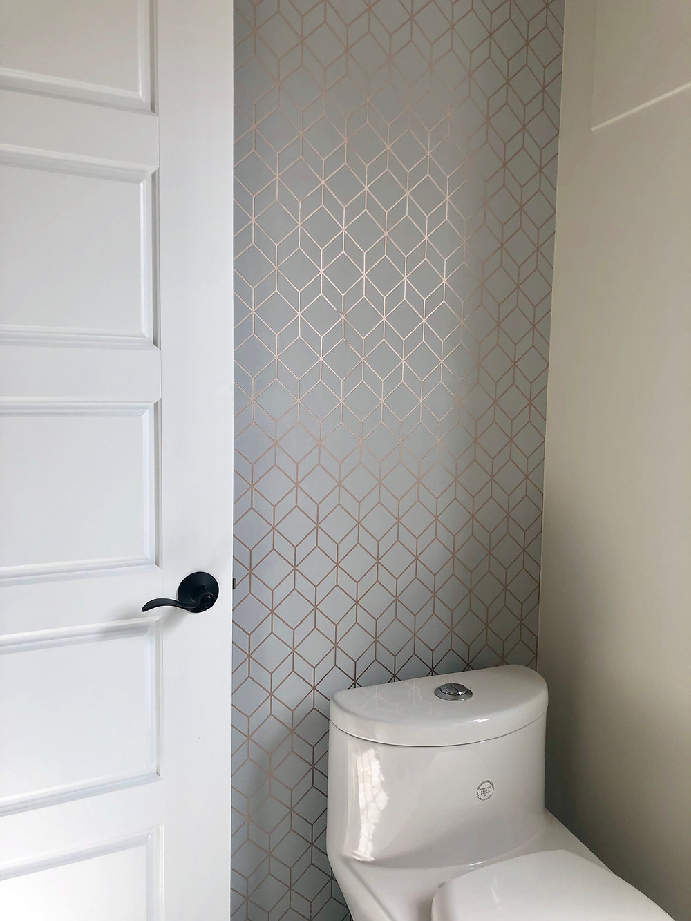 Geometric-pattern wallpaper in rose gold and grey