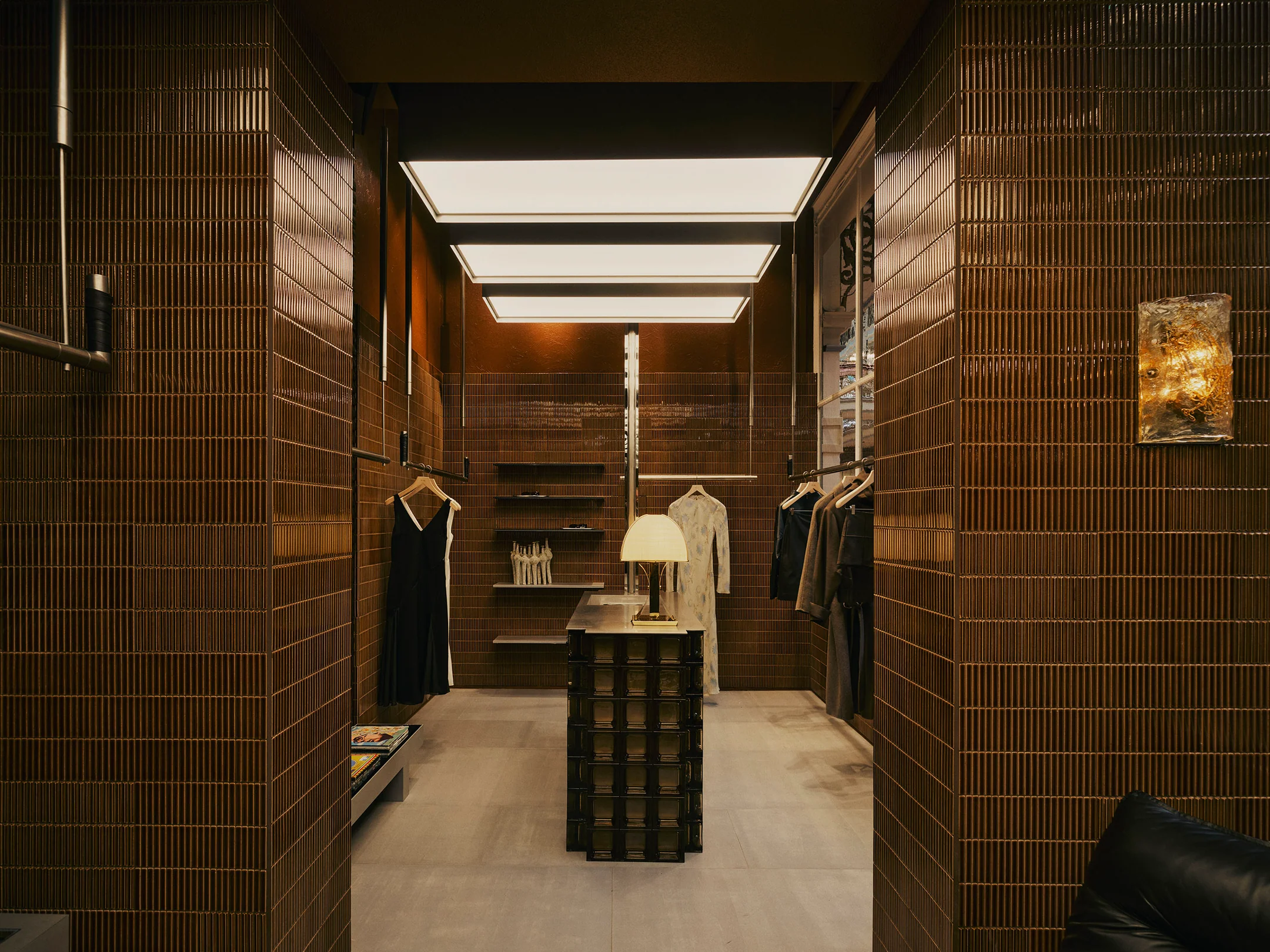 SIR. boutique in Sydney’s Strand Arcade, with dark brown mosaic tiles and linear lighting.