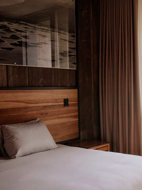 Bedroom of Flavia hotel in Oaxaca by RootStudio, minimalist interior and valley view.