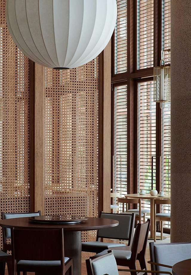 Interior detail of Sanya Wellness Retreat by Neri&Hu, with timber screens, woven cane and filtered light.