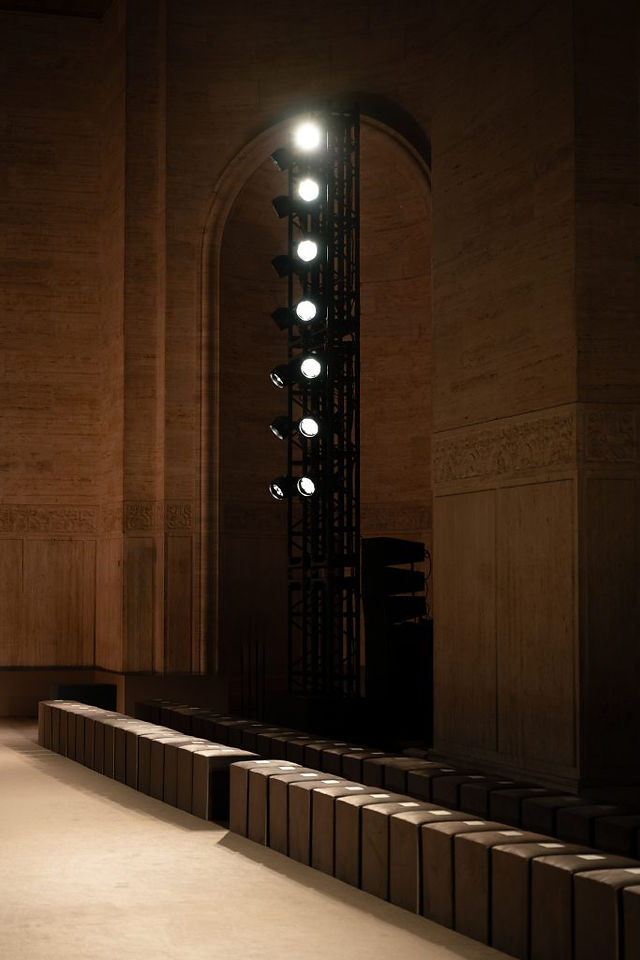 Coach Autumn 2026 runway at the Cunard Building, framed by a monumental arch and a luminous installation.