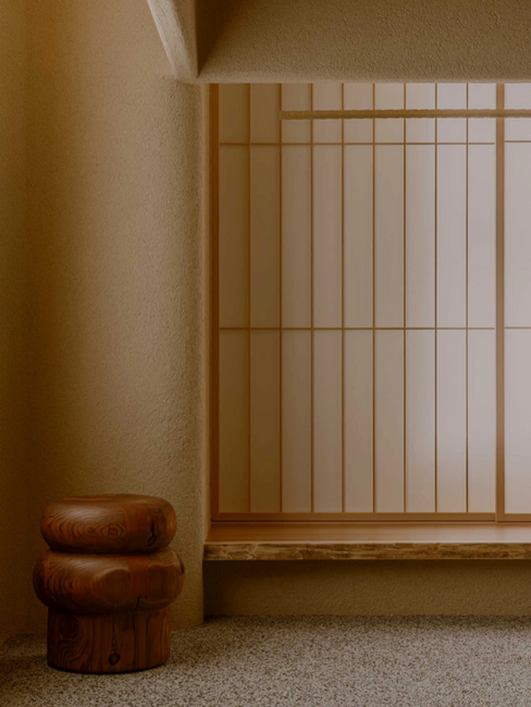 Eunoia fashion boutique in Kobe with a timber screen and a sculptural stool.