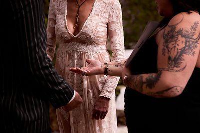 utah wedding officiant jenn wilde holding rings for a couple during elopement