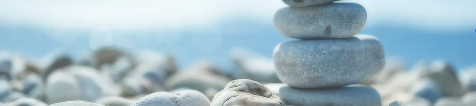 Stacked stones at a beach indicating a memorial