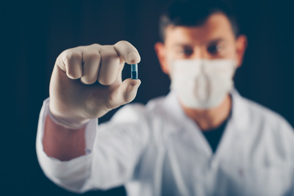 doctor-with-mask-gloves-holding-blue-pill-with-his-fingers-side-view (Large).jpg