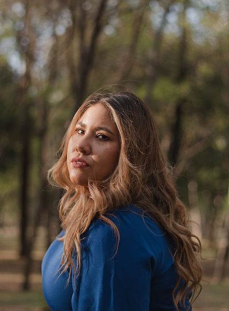 rtistic portrait of a smiling woman with soft lighting highlighting her expressive eyes and natural charm