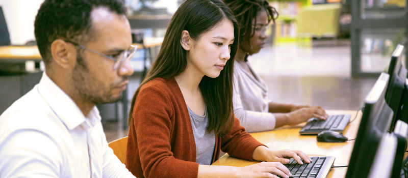 Adult learners completing an English assessment for LINC classes