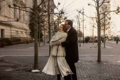 woman wearing vintage fur coat dances with man outside the met museum