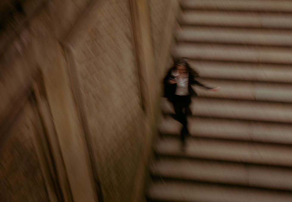 blurry photo of a woman running down the steps of bethesda terrace