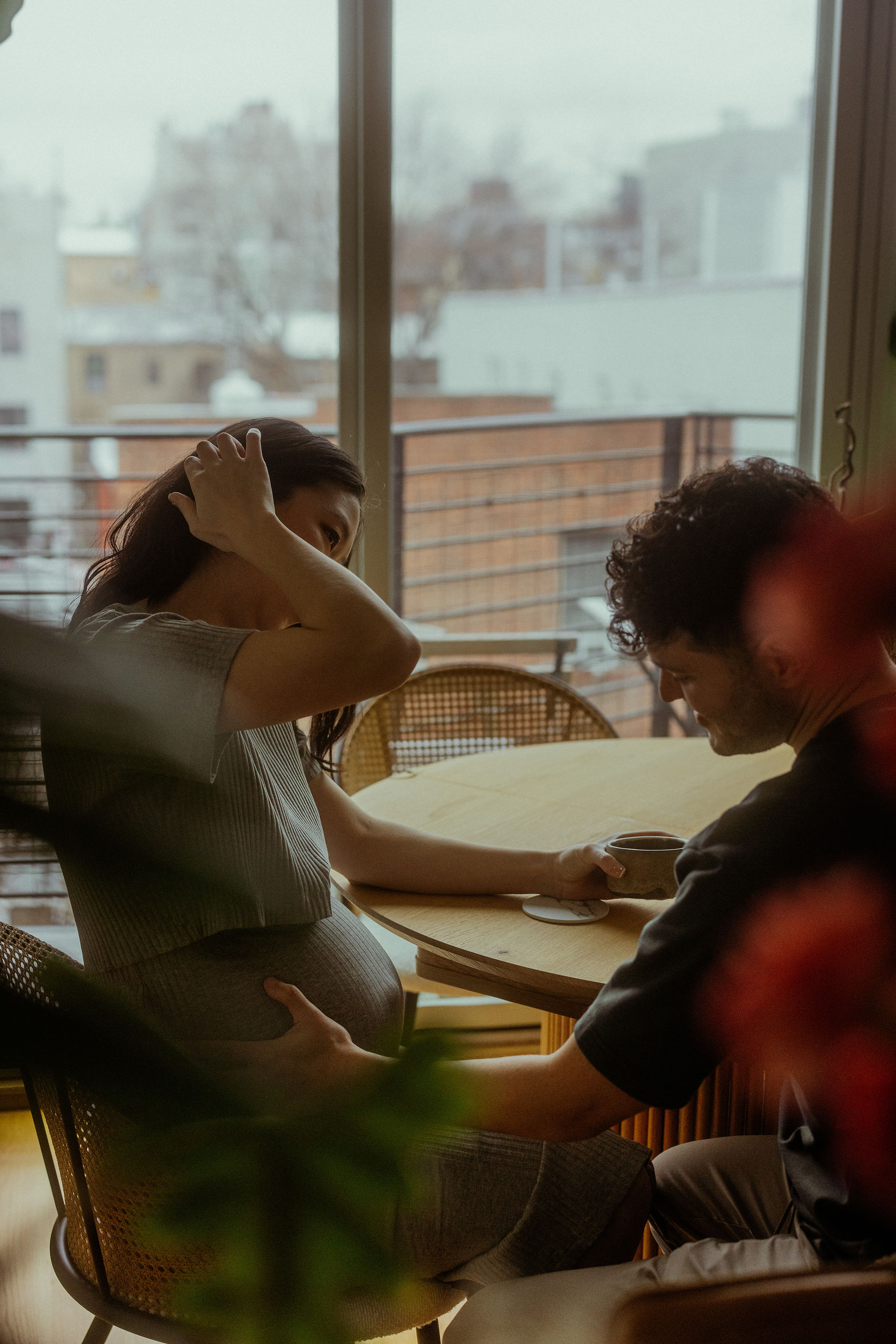 man touches woman's pregnant belly