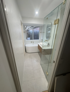 Bathroom renovation in Logan showing a new bath, vanity (taps) and shower
