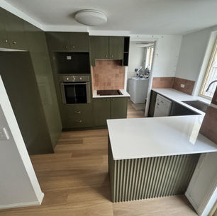 Olive green kitchen with white benchtops