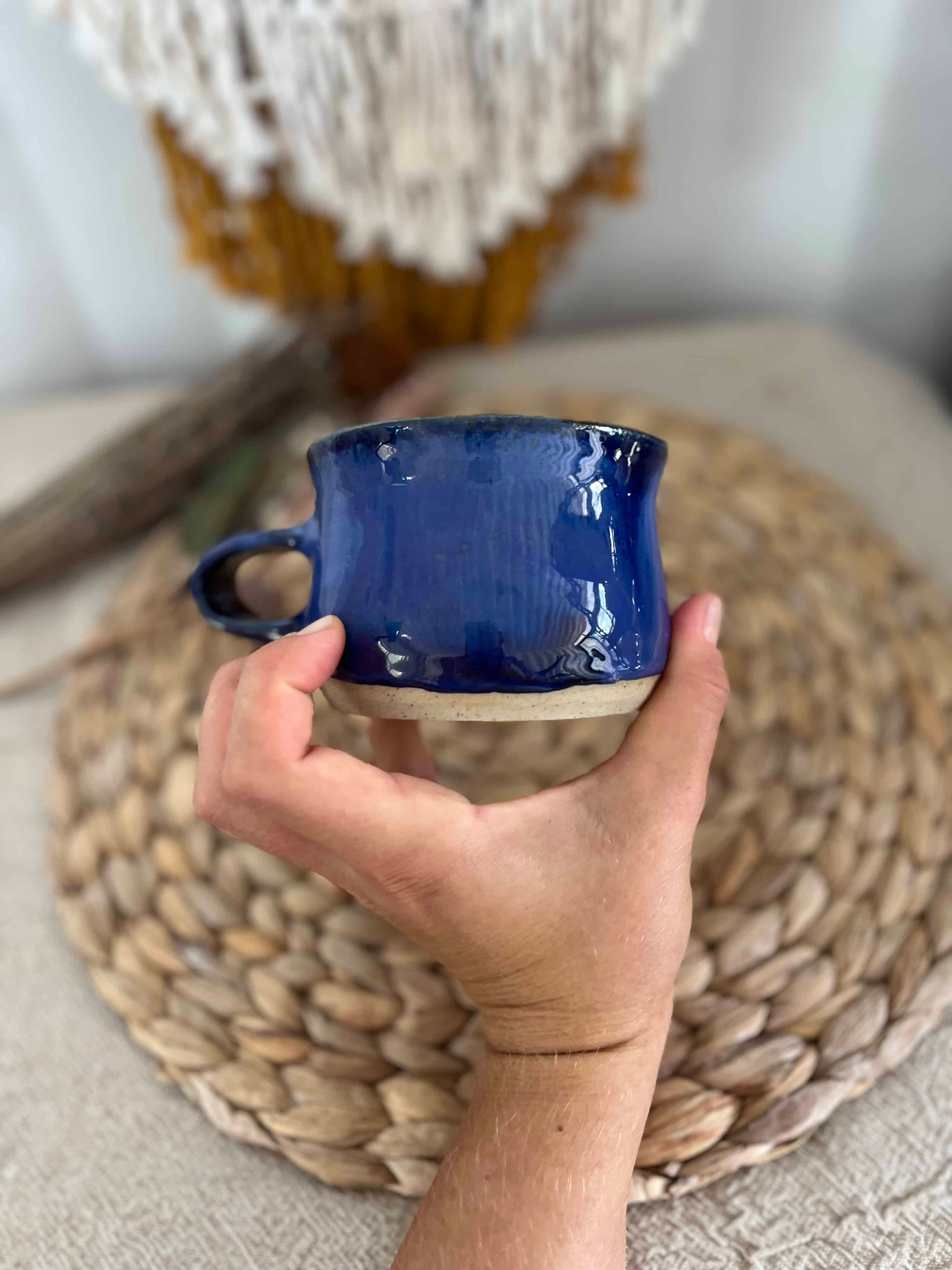 Royal blue glazed handmade ceramic mug with a handle, gold rainbow and moon impression