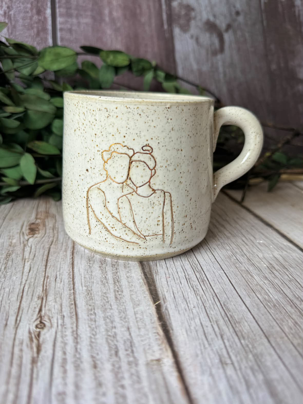 Personalised mug in white with line-art illustration of a couple in gold