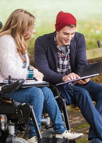 Woman in a wheelchair sits beside her lifestyle support worker in a Toowoomba park