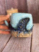 Light teal mug with dark blue textured wave and etched detailing