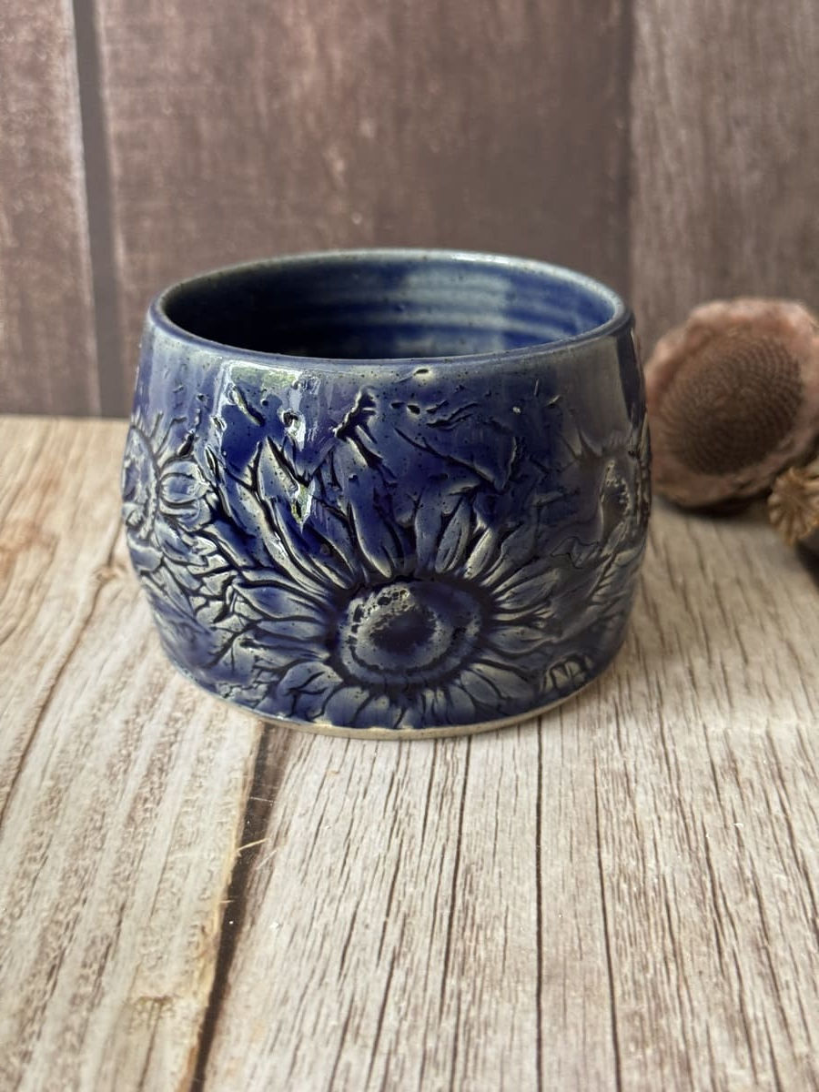 Wonky hug mug in deep blue with sunflower pattern impression
