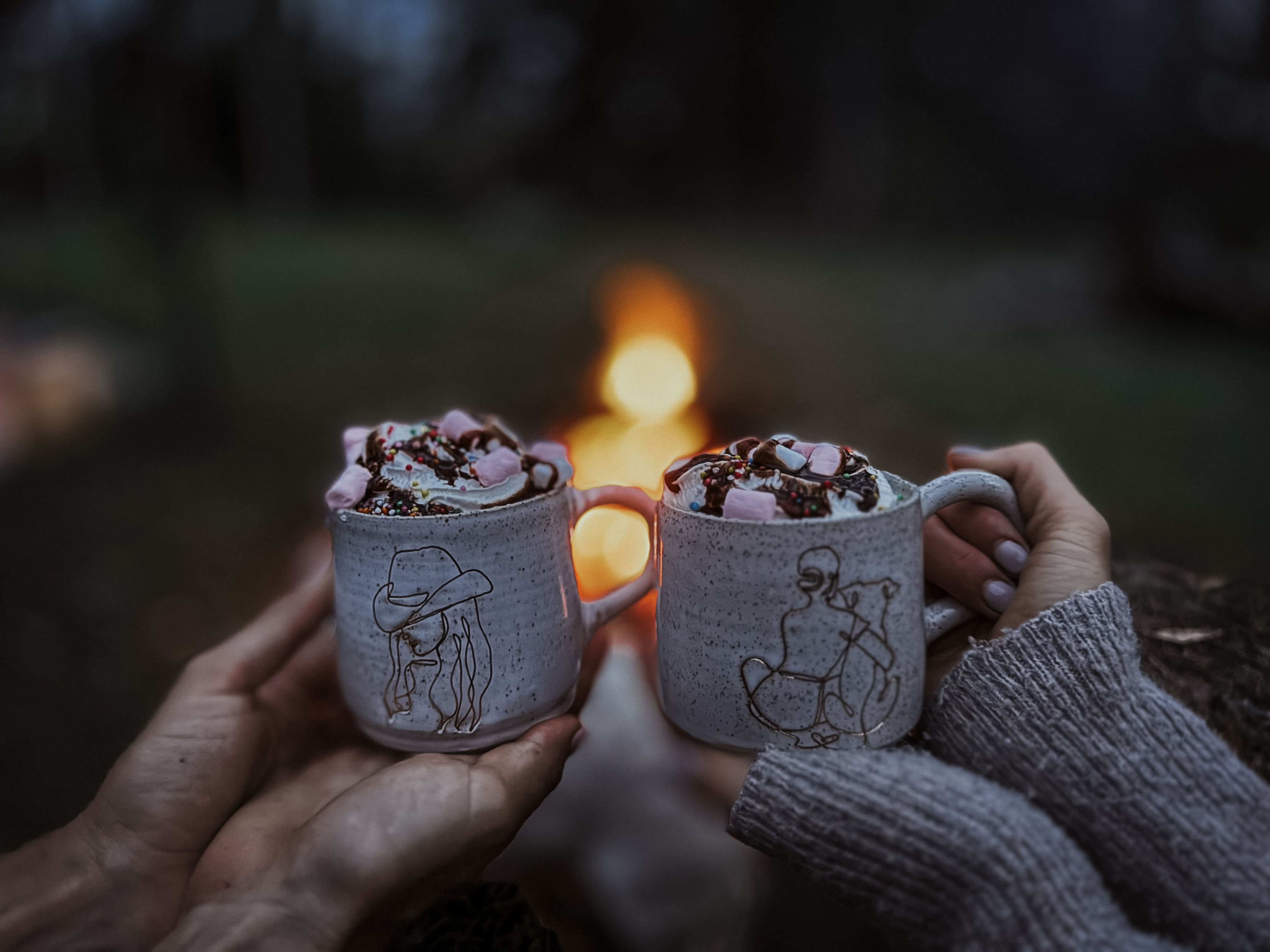 Cowgirl mug with a different design around the campfire