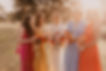 Bride and bridesmaids holding vibrant bouquets from a Toowoomba wedding florist