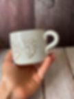 Gold-lined paw prints on a mug with pets names