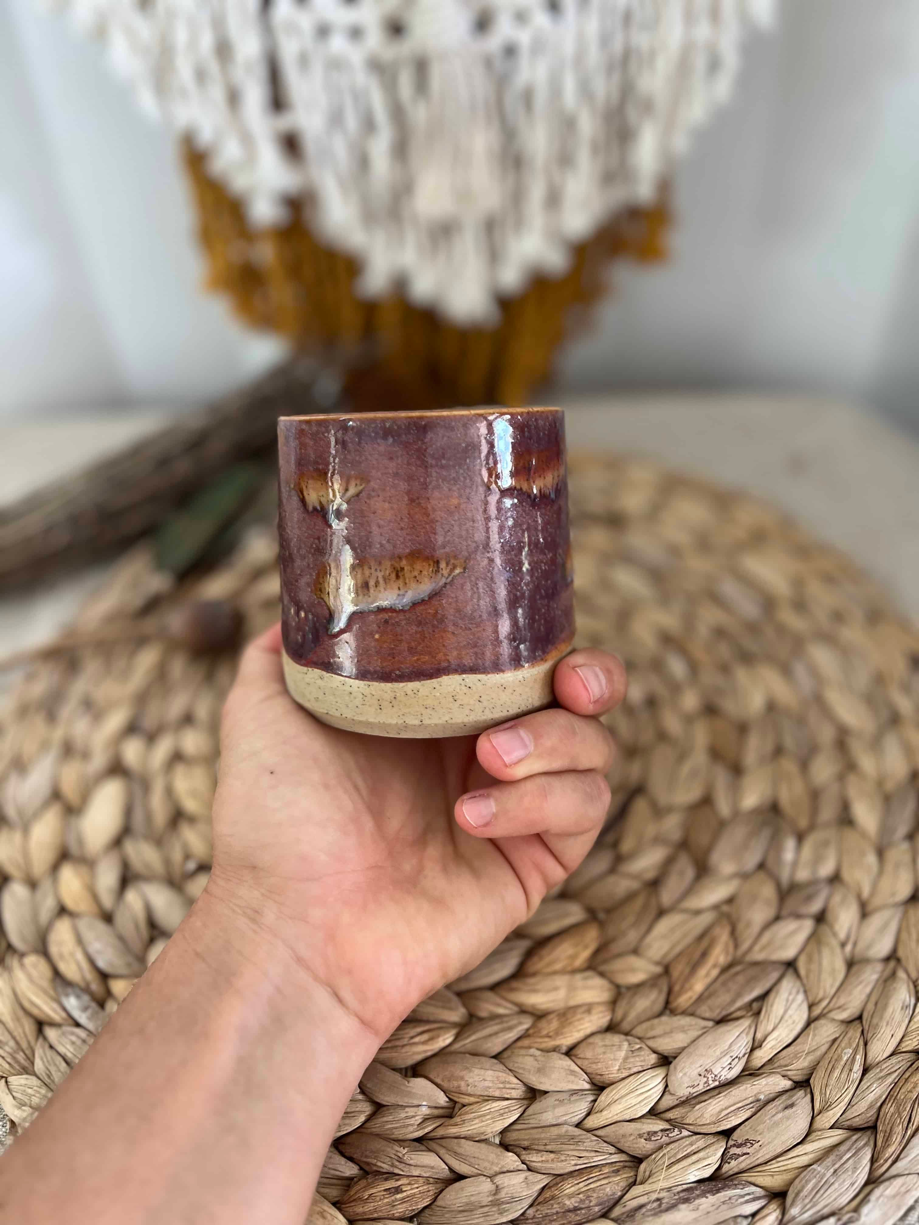 Handmade ceramic mug with brown glaze, speckled raw ceramic, and a brown stamped quokka